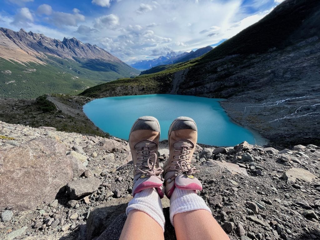 View over hiker's feet of Huemul Lagoon near El Chalten in Argentina