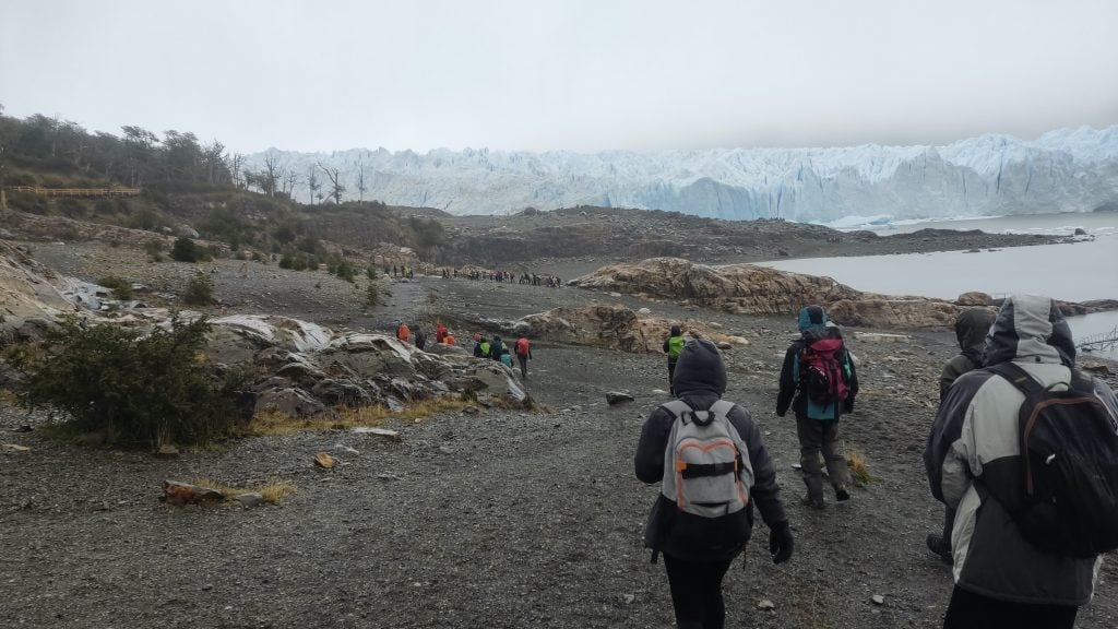 Hikers walk to the ice at Perito Moreno glacier in Los Glaciares