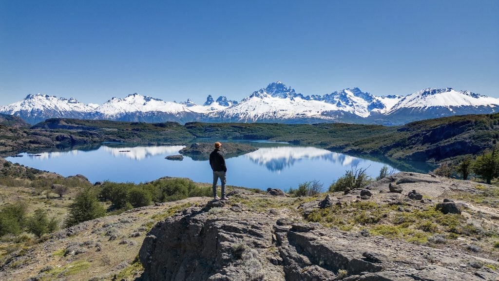 Tourist looking at the distant Cerro Castillo Mountains in Aysen, on a trip along the Carretera Austral highway